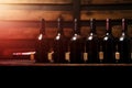 Bottles of red wine on a wooden shelf. banner background for winery, bar or shop Generative AI. Royalty Free Stock Photo