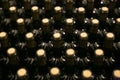 Bottles in a row at wine cellar. Stacked up wine bottles in the cellar Royalty Free Stock Photo