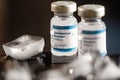 Bottles Of Sars-Cov-2 Coronavirus Vaccine With Melting Ice On Foreground. close up, studio shot
