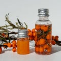 Bottles of sea buckthorn oil with a branch of sea buckthorn berries and a copy space. Royalty Free Stock Photo