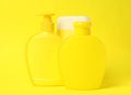 Bottles of shampoo on yellow. Natural cosmetic products Royalty Free Stock Photo