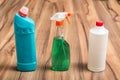 Bottles and spray products for household cleaning on the wooden floor. Cleaning concept. Royalty Free Stock Photo