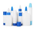 Bottles and sticks of glue on white background Royalty Free Stock Photo
