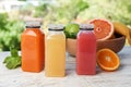 Bottles with tasty juices and ingredient Royalty Free Stock Photo