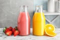 Bottles with tasty juices and ingredients Royalty Free Stock Photo