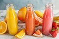 Bottles with tasty juices and ingredients Royalty Free Stock Photo