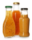 Bottles with tasty sauces on white background