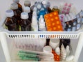 Bottles of tinctures and antiseptics, pills, drops, gels, syringes and other medications are on the shelves. Medical background