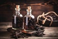 Bottles with vanilla aromatic oil and vanilla pods on a wooden background Royalty Free Stock Photo