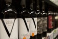 Bottles of white wine on the shelves in the store. Close-up. Moscow, Russia, 01-01-2021 Royalty Free Stock Photo
