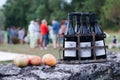 Bottles of wine and apples on a rock wall.