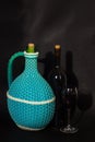 Bottles of wine. Wicker bottle with handle, glass of wine and braided basket