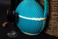 Bottles of wine. Wicker bottle with handle, glass of wine and braided basket