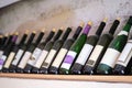 Bottles of wine on a wooden shelf in the restaurant