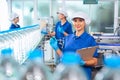 Bottling factory worker inspecting quality of water bottles before shipment. Reverse osmosis system used in plant. water Royalty Free Stock Photo