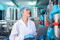 Bottling factory worker inspecting quality of water bottles before shipment. Reverse osmosis system used in plant. water Royalty Free Stock Photo