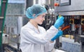 Bottling factory worker inspecting quality of water bottles before shipment. Reverse osmosis system used in plant. water Royalty Free Stock Photo