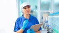 Bottling factory worker inspecting quality of water bottles before shipment. Reverse osmosis system used in plant. water Royalty Free Stock Photo