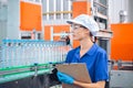 Bottling factory worker inspecting quality of water bottles before shipment. Reverse osmosis system used in plant. water Royalty Free Stock Photo