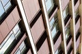 Bottom angular view of building with maroon walls and windows