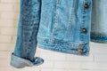 Bottom of Blue denim woman jacket. Clothes fragment