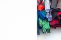 Bottom of boy jackets and winter clothes hanging in a real closet with lots of white space for copy, room for text