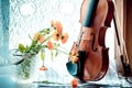 Bottom half of a violin with sheet music and flowers the front o Royalty Free Stock Photo