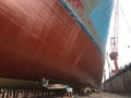 Bottom of the huge ship in dry dock during painting