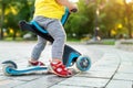 Bottom part and legs of cute adorable little caucasian toddler boy in having fun riding three-wheeled balance run bike Royalty Free Stock Photo