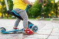 bottom part and legs of cute adorable little caucasian toddler boy in having fun riding three-wheeled balance run bike Royalty Free Stock Photo