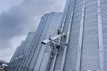 Bottom perspective of storage Tower Silos in a group of grain corrugated steel tanks. Agricultural business