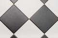 Bottom tiles in black and white laid out in diamond pattern