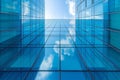 Bottom-up perspective view of modern office building with glass walls against the blue sky. The sky and light clouds are Royalty Free Stock Photo