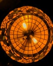 Bottom up view of an antique looking lamp with light bulbs glowing.