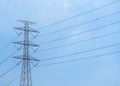 High voltage electric post and electric cable with cloud and blue sky as background. Royalty Free Stock Photo
