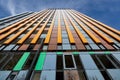 Construction process a modern office building against a blue skys. Glazing of facade of a residential building, hotel or Royalty Free Stock Photo