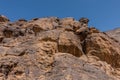 A rock cliff with the pre-islamic inscriptions at the north entrance of Wadi Massal, Riyadh Province, Saudi Arabia