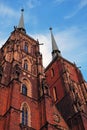 Bottom up view of two brick spires of the gothic cathedral of Saint John the Baptist in Ostrow Tumski, Wroclaw, Poland