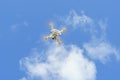 Bottom up view of a drone hovers in blue sky