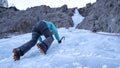 BOTTOM UP: Woman ice climbing in the Julian Alps stops and looks at her crampons