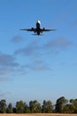 Bottom view of airplane flying above the fields near airport Rome-Fiumicino Royalty Free Stock Photo