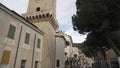 Bottom view of an ancient church with a tower and old clock on blue cloudy sky background, religion and architecture Royalty Free Stock Photo