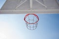 Bottom view of the background of a basketball hoop against the blue sky. Royalty Free Stock Photo
