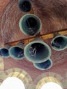 Bottom view of bells with installed microphones on bell tower of Orthodox church. Brickwork of domed vault from inside. Close-up.
