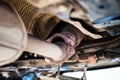 Bottom view of broken muffler on car Royalty Free Stock Photo