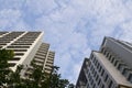 Bottom view of building against with beautiful white clouds and blue sky Royalty Free Stock Photo