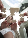 Bottom view. business team folding puzzle pieces. . Royalty Free Stock Photo