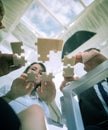 Bottom view. business team folding puzzle pieces. . Royalty Free Stock Photo