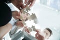 Bottom view. business team folding puzzle pieces. . Royalty Free Stock Photo