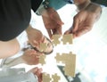 Bottom view. business team folding puzzle pieces. . Royalty Free Stock Photo